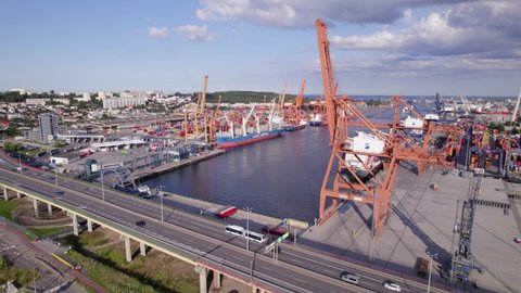 Port of Gdynia. Seaport, containers, container ships and sea transport from the bird's eye view on a sunny day.