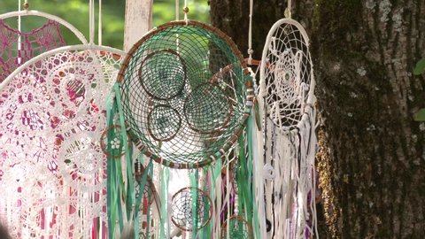 Dream catcher in the wind. Handmade magic dreamcatcher over nature background earth. Handmade Amulet and esoterics concept. Wild nature materials