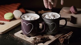 Hand of Man Putting Marshmallows into a Cup of Cocoa or Hot Chocolate Indoors, Slow Motion - Powered by Shutterstock - Get 15% off with code: PIKWIZARD15