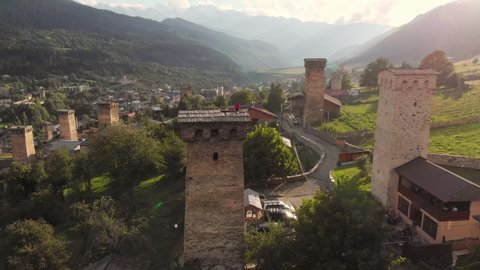Flying around of the famous historical Svan towers at sunset in Mestia, Svaneti region, Georgia. Mestia is a highland town in Georgia in the Caucasus Mountains.