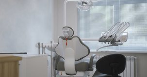Modern dental clinic. Empty minimalistic dental office with dental chair and professional equipment. High quality 4k video. Shot with RED camera.