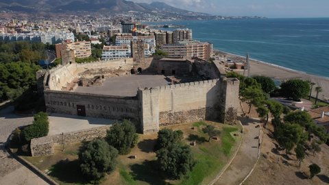 Aerial 4K video from drone to Fuengirola historic Sohail Castle. Is shown in the background Rio Fuengirola Pedestrian Bridge.Fuengirola Malaga ,Spain, Europe (Series)