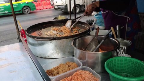 Bangkok, Thailand - Mar 3, 2020. Pad Thai, a popular Thai food of backpack tourists. Street Vendor Sell and Packaging Stir Fried Pad Thai Noodle. Traditional Thai Street Food.