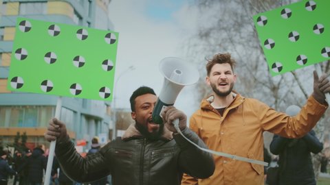 Black life matters protests on city streets. African and White men marching together with green screen chroma key banners. Rally for matter of blacks lives. Riot activists with megaphone bullhorns.