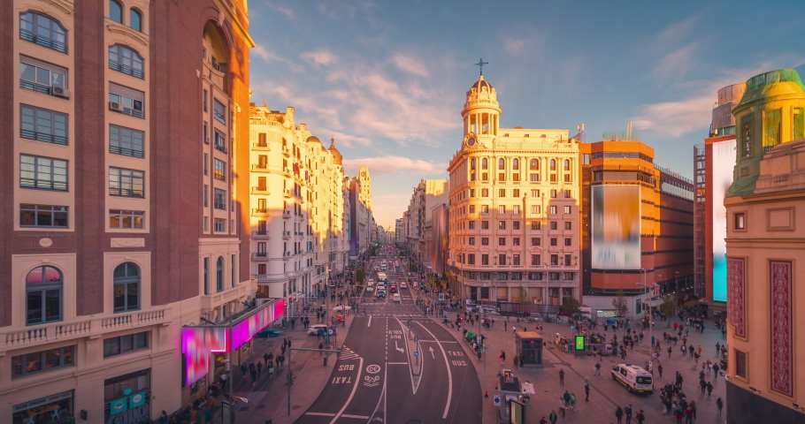 Day to night time lapse of Gran Via street in Madrid, Spain. Crowd and traffic on main street during sunset wide angle aerial point of view Royalty-Free Stock Footage #1083800758