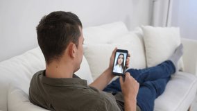 Man at home conducts a video meeting with a doctor, interacts online during social distancing and self-isolation.