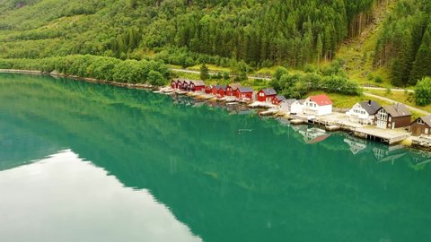 Beautiful cottage houses on the edge of a magnificent lake in Norway - Aerial view 
