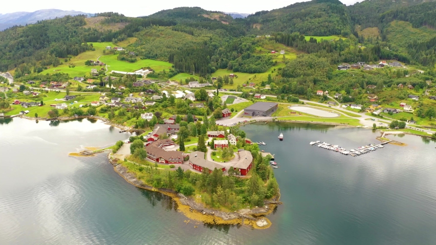 Beautiful town on a lake surrounded by green mountains in Norway