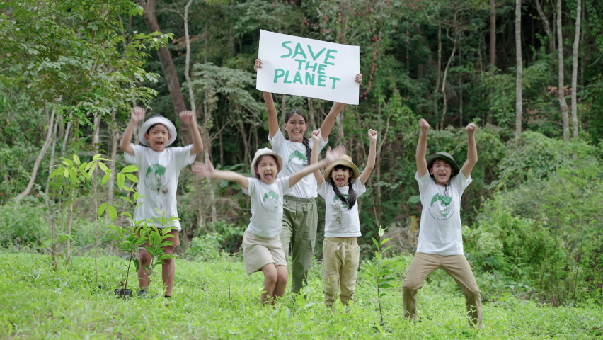 Children join as volunteers for reforestation,children holding up signs to save the planet, earth conservation activities to instill in children are patient, selfless and loving nature.
