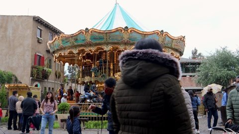 Tlaxcala, Mexico - June 2021: Timelapse of a carousel in the town of Val'Quirico, a place where people can go for a walk and eat in international food restaurants as well as enjoy games.