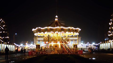 Illuminated Venetian carousel filmed at night.KYIV-13 DECEMBER,2021