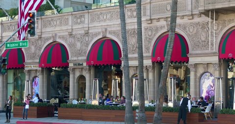 LOS ANGELES, CALIFORNIA, USA - NOVEMBER 28, 2021: People enjoy food at Beverly Wilshire Hotel landmark restaurant on Rodeo Drive in Beverly Hills, Los Angeles, California, 4K