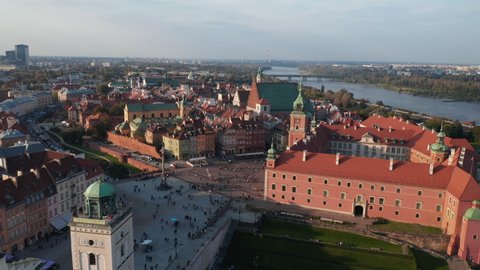 Aerial view of Royal castle complex and Castle square in old town. Tilt down focusing at house rooftops. Warsaw, Poland