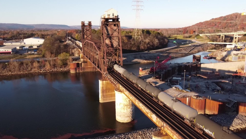 Tenbridge is a vertical-lift railroad bridge over the Tennessee River in Chattanooga, Tennessee. Cargo Train Moving On Railroad Bridge.Freight Train Passing Railroad And River.