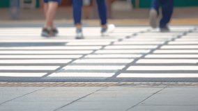 Anonymous people crossing a crosswalk in Japan, feet only
