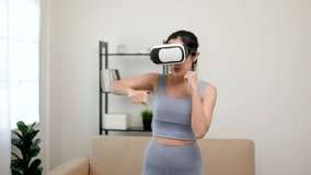 Boxing training with virtual sport at home. Young asian sport woman wearing sportswear workout with virtual simulated world. Into the future digital cyber universe. Future technology vr.