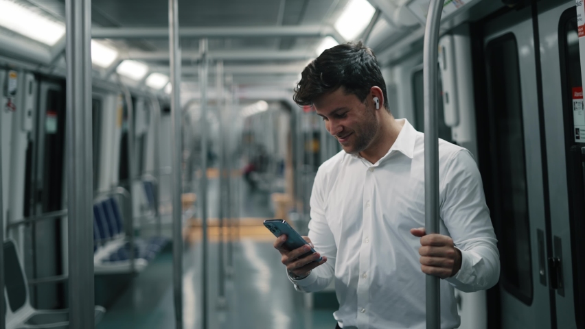 Businessman using smartphone in train