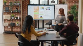 Company workers planning business presentation, collaborating on graphs and charts to research financial growth. Diverse team of partners meeting in boardroom for executive cooperation. - Powered by Shutterstock - Get 15% off with code: PIKWIZARD15