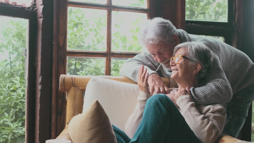 Portrait of happy couple old people seniors hug together, looking at the camera, loving to mature wife and husband with healthy playful smile posing to family picture at home.
 Royalty-Free Stock Footage #1083859984