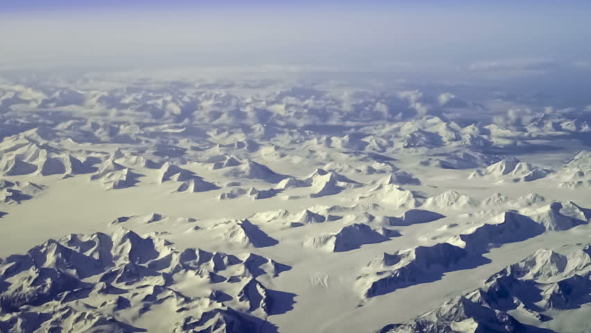 Aerial view of arctic mountains near Kluane National Park, Yukon Territory, Canada. Steady, slow motion shot.