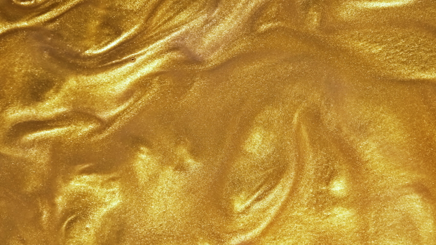 Liquid gold motion organic background. Shine glitter fluid metallic yellow color paint. Texture abstract acrylic cloud swirling underwater. Royalty-Free Stock Footage #1083863953