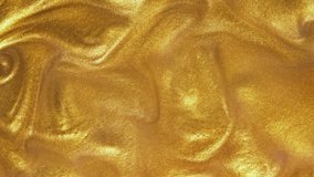 Liquid gold motion organic background. Shine glitter fluid metallic yellow color paint. Texture abstract acrylic cloud swirling underwater. - Powered by Shutterstock - Get 15% off with code: PIKWIZARD15