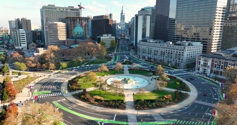 Rising aerial of Logan Circle in downtown Philadelphia. City Hall in distance. Urban city in Pennsylvania, USA.