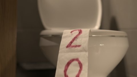 Ending 2021, humorous footage of paper roll being sucked into sanitary toilet after flushing water, slow motion