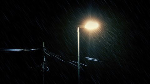 Streetlamp And Phone Lines Swaying On Rainy Night