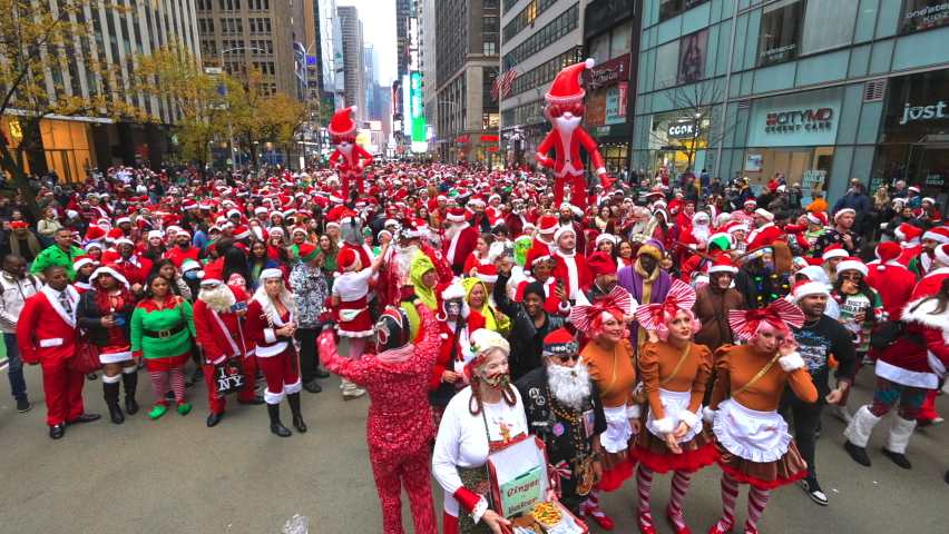NEW YORK, NEW YORK – DECEMBER 11: A crowds of people attend the annual SantCon in Times Square on December 11, 2021in New York City. People celebrate the SantCon is back in New York City, which event 