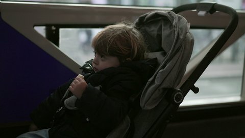 Baby toddler riding bus transportation, child sitting inside stroller