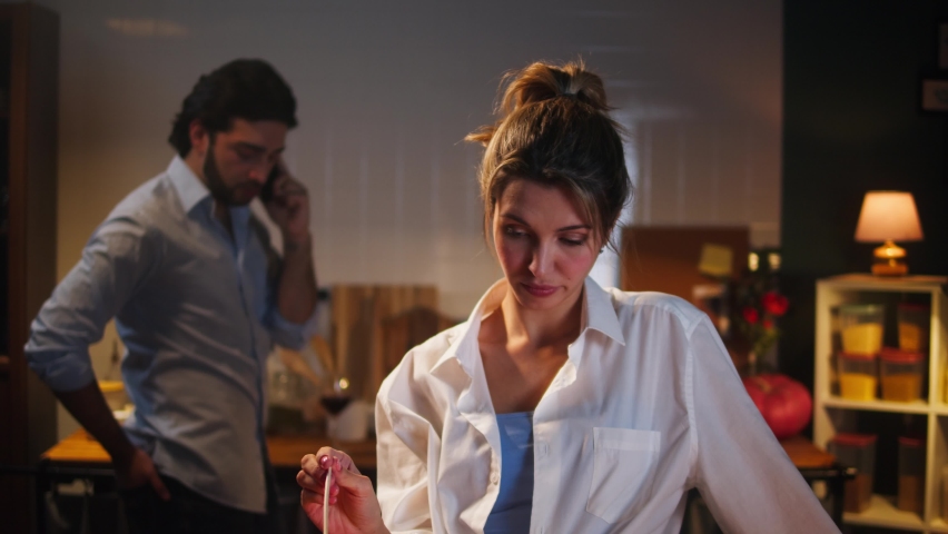 Offended housewife waiting for husband speaking on smartphone. Busy man and sad woman having romantic dinner in cozy kitchen. Family relationships, problems and conflicts in marriage.  Royalty-Free Stock Footage #1083887284