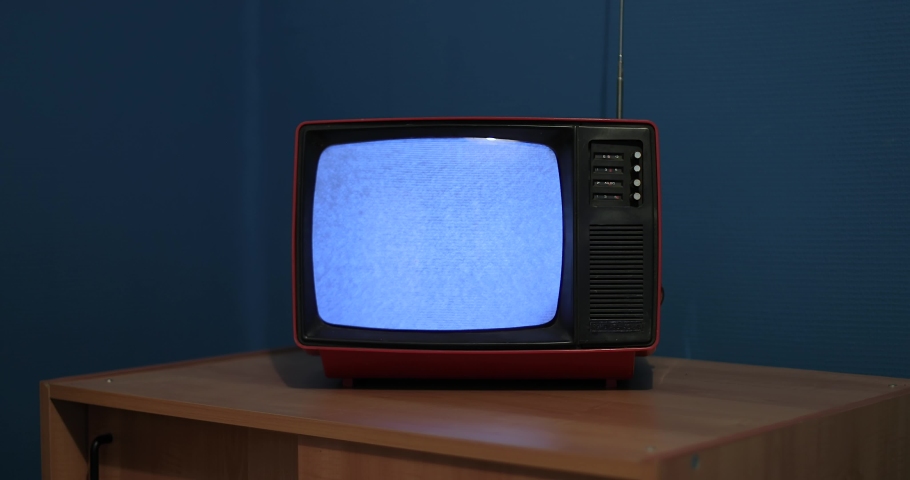 Old TV set with no reception noise in a dim room glow of the screen. Black and white television, dim bedroom | Shutterstock HD Video #1083890212