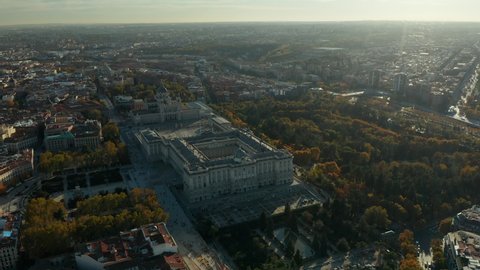 Aerial footage of Royal Palace and Almudena Cathedral at golden hour. Autumn colour foliage in parks and gardens.