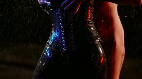 two lesbians are dancing and stroking bodies, closeup of female hips, wearing bdsm suits
