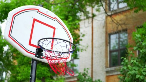 Basketball hoop outdoor. Urban street basketball court. Daytime for basketball practice. Urban youth game. Concept of success, scoring points and winning. Determination, Endurance, Motivation, Effort