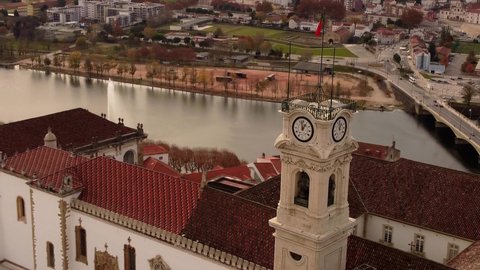 Coimbra aerial view of the clock tower of university with Portugal flag drone footage of the old city town