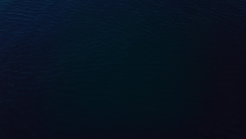 aerial reveling up the Oceanside Pier across the sea. Cityscape as backdrop