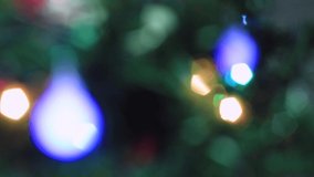 Blurred Christmas eye-catching multicolored lights are burning brightly. New Year's light out of focus. Video, footage for screensaver, intro, presentation, transition, congratulations, effects UHD 4K