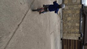 POV Cute little boy 4-5 years old toddler baby boy child riding bike in sunny summer day, kid playing and cycling at park, Cycling with young kids concept. Vertical video stories.