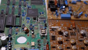 Lots Old Boards with Radio Components, Transistors, Chips, Resistors, Capacitor. Electronic circuit boards of retro TVs with precious metal, gold, platinum, silver, tantalum. Scheme. 4K. Close-up - Powered by Shutterstock - Get 15% off with code: PIKWIZARD15