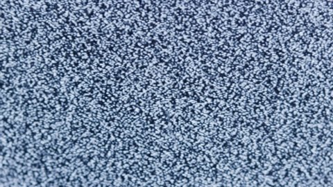 distorted white static noise interference on a small portable analog TV with a cathode ray tube, full frame real time, shutting down in the end