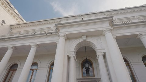 Facade of Livadia Palace in Crimea. Action. Beautiful facade of white old building with columns in European style. Tourist former palace in Crimea