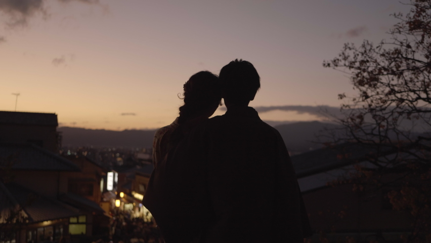 Japanesse couple watching sunset at Kiyomizudera temple in Kyoto
