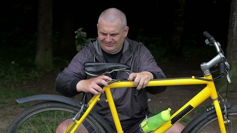 Man fixing bicycle seat