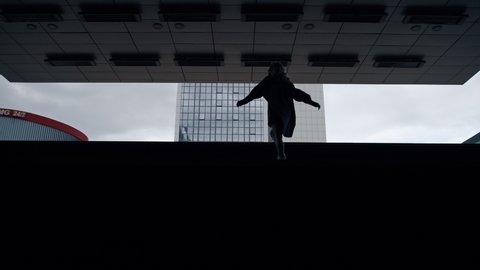 Silhouette woman going up stair from subway underground on daylight. Unknown female person walking up on staircase in modern city background. Walking and urban city lifestyle concept. 