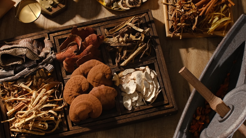 Lighting of herb and species mushroom anise turmeric in a wooden tray for traditional medicine advertising , top view