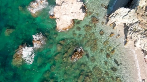 Beautiful rocks on the beach, Elba Island overhead view, Italy. Slow motion