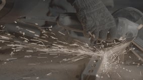 Steel cutter with sparks while cutting steel bar. 4K 50 fps. RAW footage for creators to color grade and control the look of your project.