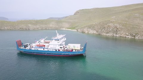 Russia, Olkhon - July 27, 2018: The mooring of the ferry Semen Batagayev. Lake Baikal. Ferry to Olkhon Island. From the side of the island., Aerial View Hyperlapse, Point of interest